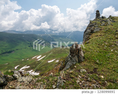 Rocky cliff above a picturesque mountain valley 128099891