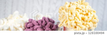 Fluffy yarn. Colored threads in reels. Knitting hobby embroidery Fluffy yarn. Colored threads in reels. Knitting hobby embroidery 128100494