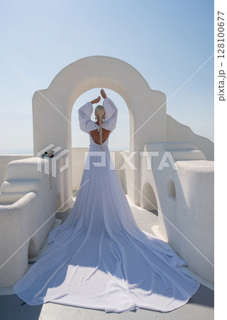 Wedding dress Santorini, woman celebrates romance in Greece at daytime on white architecture. Wedding dress Santorini, woman celebrates romance in Greece at daytime on white architecture. 128100677