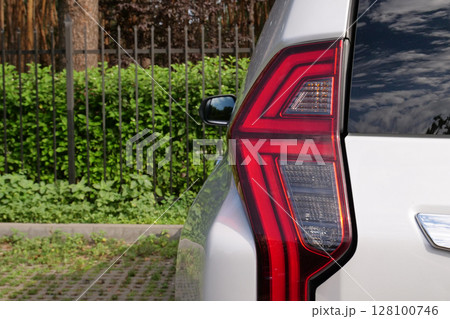 Back Light Of Vehicle Stay In Front Of Fence Of Forest Park  128100746