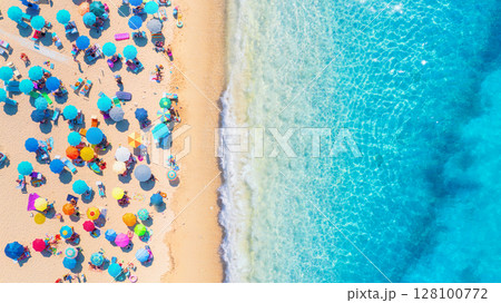 Beach, people and umbrellas. Top view from drone at the beach and azure sea. Beach, people and umbrellas. Top view from drone at the beach and azure sea. 128100772