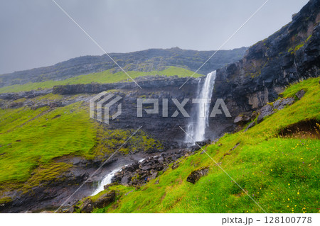 Waterfall on Faroe Islands, Denmark. Scenic place for travel. Waterfall on Faroe Islands, Denmark. Scenic place for travel. 128100778