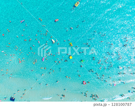 People relax at the sea. Vacation and holiday on the sea coast. Swimming and diving. People relax at the sea. Vacation and holiday on the sea coast. Swimming and diving. 128100787