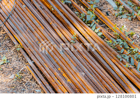 Steel rods bars, Metal, and Iron reinforcement lying on the ground on the construction site for material used for reinforcing concrete building construction. Concept background textured architecture 128100801