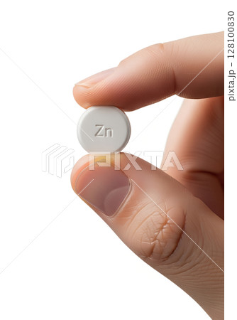 Close-up of hand holding zinc tablet, immunity booster, isolated on transparent background, dietary supplement, mineral nutrition, wellness concept Close-up of hand holding zinc tablet, immunity booster, isolated on transparent background, dietary supplement, mineral nutrition, wellness concept 128100830