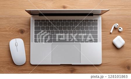 Laptop and accessories on a wooden desk, representing modern technology. 128101863