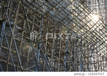 bamboo scaffolding pole cover the tower building wall cover the wan chai convention centre (HKCEE) , asian architectural background in hong kong china 128107417