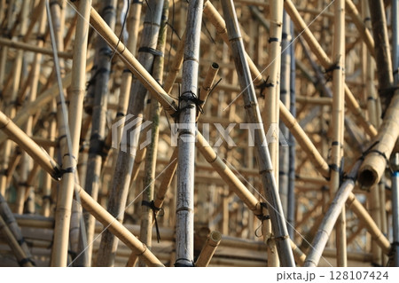 bamboo scaffolding pole cover the tower building wall cover the wan chai convention centre (HKCEE) , asian architectural background in hong kong china bamboo scaffolding pole cover the tower building wall cover the wan chai convention centre (HKCEE) , asian architectural background in hong kong china 128107424