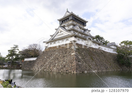 Kitakyushu, Japan - Dec 29,2022 : White tower of Kokura castle with blue sky in Kitakyushu, Japan on Dec 29,2022. Kitakyushu, Japan - Dec 29,2022 : White tower of Kokura castle with blue sky in Kitakyushu, Japan on Dec 29,2022. 128107970