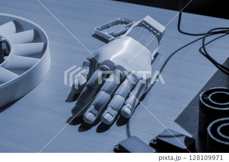 Plastic hand printed on 3D printer. Human arm prosthesis created on a 3D printer from molten plastic. Plastic hand, fingers, nails printed on 3D printer. Modern new additive 3d printing technologies 128109971