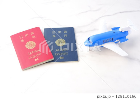 日本のパスポート(10年用赤色と5年用紺色)と飛行機で、長期休暇に海外旅行を計画しているイメージ 日本のパスポート(10年用赤色と5年用紺色)と飛行機で、長期休暇に海外旅行を計画しているイメージ 128110166