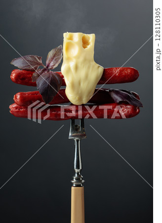 Grilled thin sausages with cheese and basil. 128110305