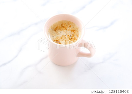 ミルクをたっぷり入れたコーヒー、カフェ・ラテを淹れて、のんびりくつろいでいるイメージ ミルクをたっぷり入れたコーヒー、カフェ・ラテを淹れて、のんびりくつろいでいるイメージ 128110408