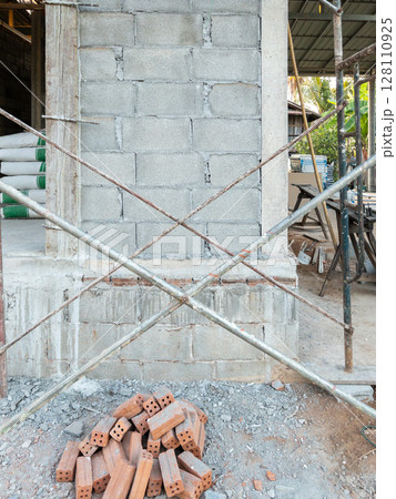 Construction Scaffolding Along Unfinished House Wall. Construction Scaffolding Along Unfinished House Wall. 128110925