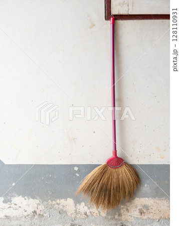 Old Broom Hanging on Rural House Wall. Old Broom Hanging on Rural House Wall. 128110931