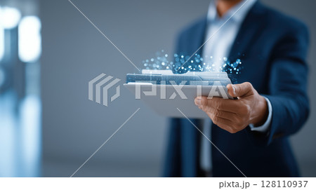 Businessman in suit holds digital tablet with holographic files, symbolizing modern technology and data management 128110937