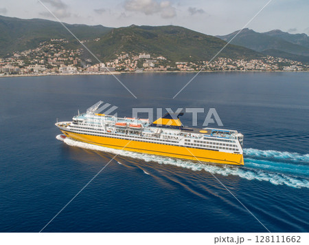 Big yellow passenger ferry goes on the Mediterranean Sea near Corsica island, France aerial view Cityscape Bastia port Big yellow passenger ferry goes on the Mediterranean Sea near Corsica island, France aerial view Cityscape Bastia port 128111662