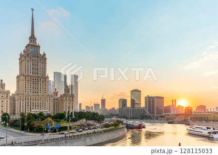 High-rise stalinist building near river at summer sunset in Moscow, Russia. Historic name is Hotel Ukraine. 128115033