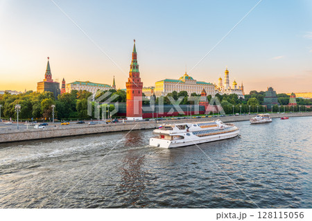 View of Kremlin with Vodovzvodnaya tower, Grand Kremlin Palace from repaired Bolshoy Kamenny Bridge in Moscow city on sunny summer day. Cruise ship sails on the Moscow river View of Kremlin with Vodovzvodnaya tower, Grand Kremlin Palace from repaired Bolshoy Kamenny Bridge in Moscow city on sunny summer day. Cruise ship sails on the Moscow river 128115056