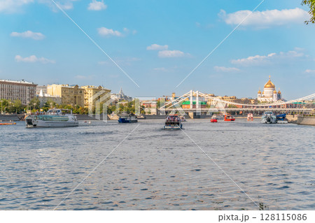 Cruise ship sails on the Moscow river in Moscow city center, popular place for walking. 128115086