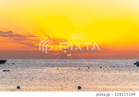 Beautiful yellow and orange sunrise over the sea. 128115194