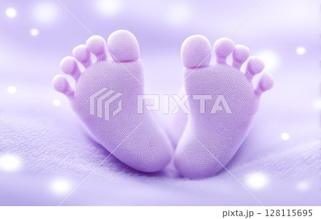 A closeup view of a baby girl's feet is set against a pastel pink blanket that wraps around them 128115695