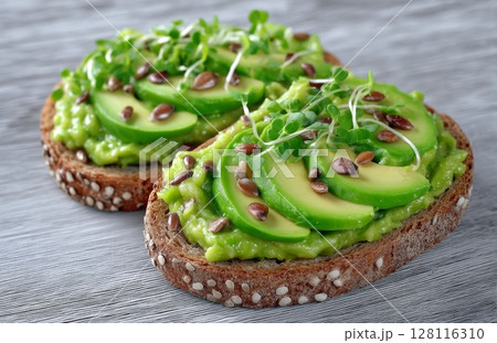Avocado and microgreen are served on trendy wholegrain toasts 128116310