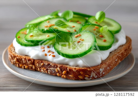 A healthy and vegetarian breakfast option is a sandwich consisting of cucumber, lettuce, microgreen, and ricotta 128117592