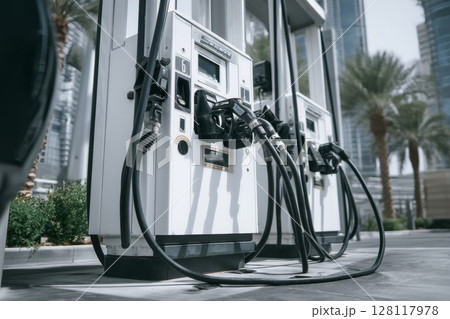 An electric car charging station is situated in a public parking lot 128117978