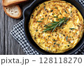 Herb omelette is mixed with chives and oregano and then another herb omelette with chili flakes is sprinkled on it 128118270