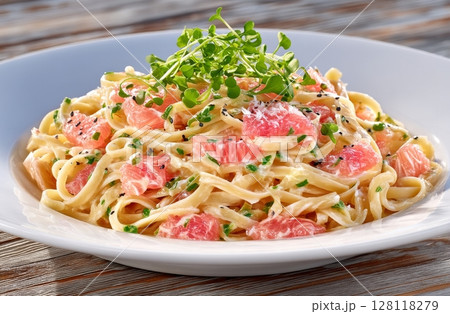 Pasta made from semolina, served with roasted garlic and topped with microherbs 128118279