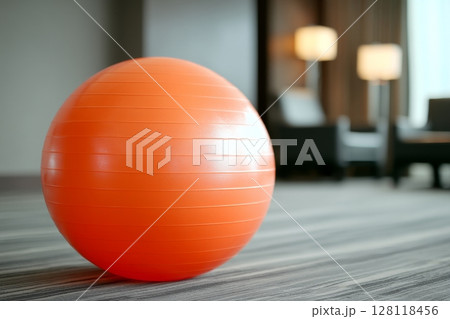 At home, an African woman who is pregnant uses an exercise mat to work out At home, an African woman who is pregnant uses an exercise mat to work out 128118456