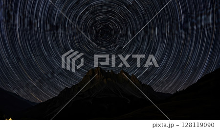 Star Trails Over Mountain Landscape at Night with Clear Skies 128119090