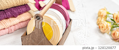 Colored ribbons and lace in coils for hobbies 128120877