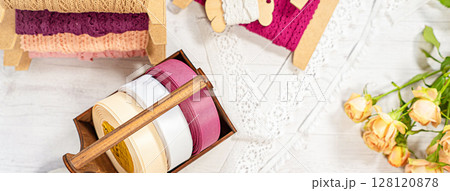Colored ribbons and lace in coils for hobbies 128120878