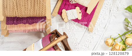Colored ribbons and lace in coils for hobbies Colored ribbons and lace in coils for hobbies 128120879