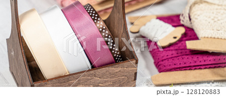 Colored ribbons and lace in coils for hobbies 128120883