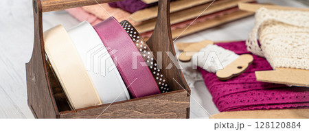 Colored ribbons and lace in coils for hobbies 128120884