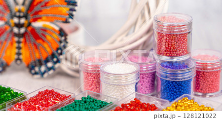 Colorful glass beads. Variety of shapes and colors to make a bead necklace or a string of beads for women 128121022