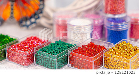 Colorful glass beads. Variety of shapes and colors to make a bead necklace or a string of beads for women 128121023