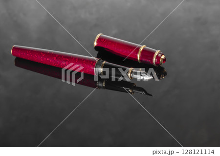 Fountain pen with box on dark gray background. Stationery branded items Fountain pen with box on dark gray background. Stationery branded items 128121114