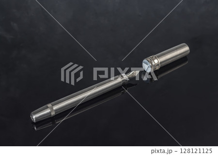 Fountain pen with box on dark gray background. Stationery branded items Fountain pen with box on dark gray background. Stationery branded items 128121125