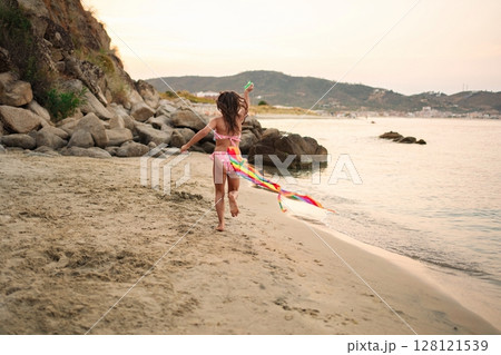 Joyful moments by the ocean with family on a sunny day 128121539