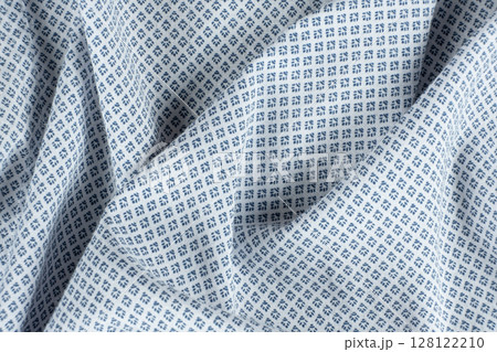 Macro texture of a fabric consisting of one hundred percent cotton. 128122210