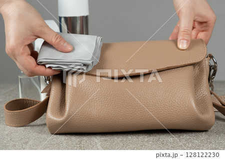 Cleaning a Leather Handbag. Gentle Care for Leather Accessories. 128122230