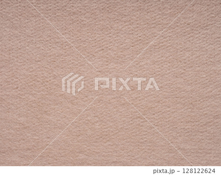 A close-up of a warm beige felt surface that evokes a soft and comforting tactile sensation, with a subtle and homely visual style 128122624