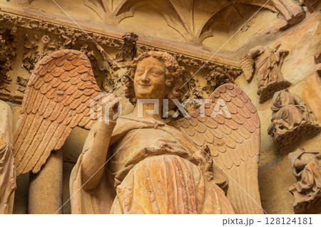 Smiling Angel, also known as the Smile of Reims or Angel of the Annunciation, is a stone sculpture at the Notre-Dame de Reims Cathedral, France 128124181