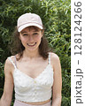 A Smiling Young Woman Embracing the Beauty of Nature While Wearing a Stylish Cap A Smiling Young Woman Embracing the Beauty of Nature While Wearing a Stylish Cap 128124266