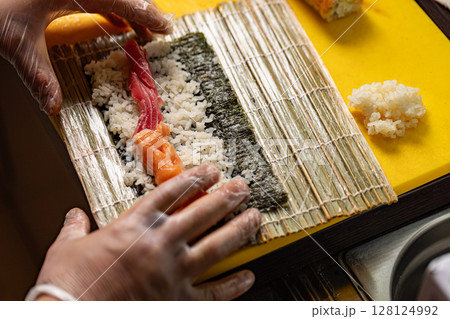 Chef preparing sushi rolls 128124992