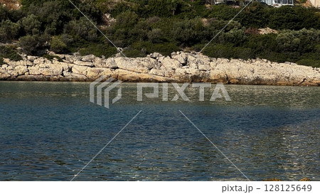 Rocky Cove with Deep Blue Water in Greece 128125649